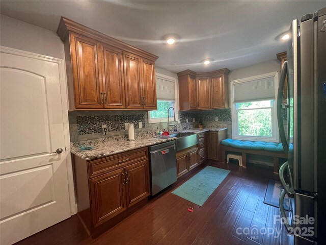 517 Grassy Creek Run, Chester, SC 29706 - kitchen with stainless steel appliances, a sink, dark wood-style floors, tasteful backsplash, and light stone counters