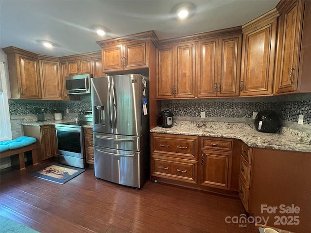 517 Grassy Creek Run, Chester, SC 29706 - kitchen featuring appliances with stainless steel finishes, backsplash, brown cabinetry, and dark wood-style floors