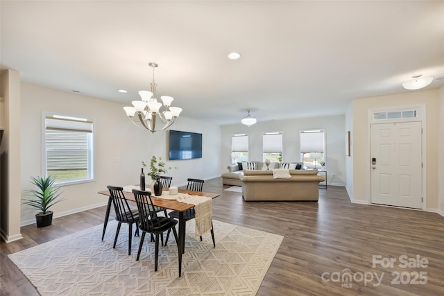 dining room featuring wood finished floors, baseboards, a chandelier, and recessed lighting