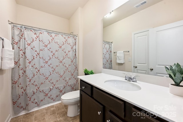 full bath with toilet, vanity, and baseboards