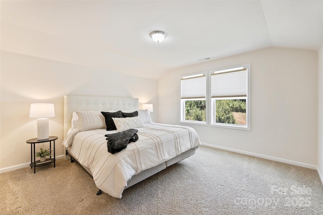 bedroom featuring lofted ceiling, baseboards, and carpet flooring