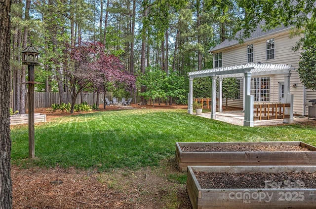 view of yard with a pergola, a patio area, and a vegetable garden