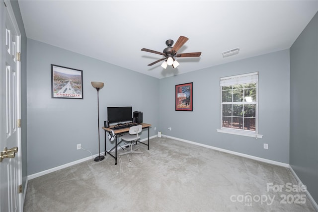 carpeted home office featuring baseboards and a ceiling fan
