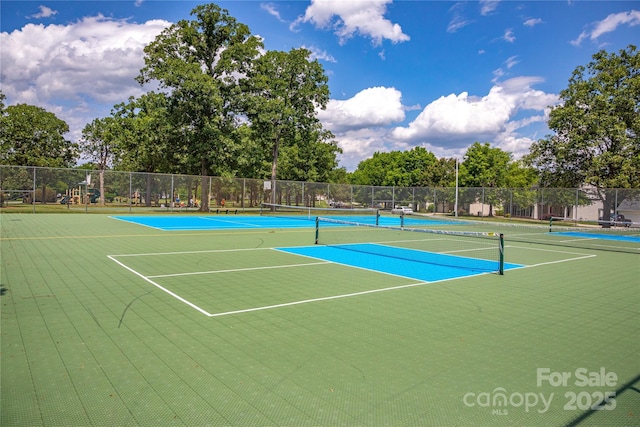 view of tennis court with fence and community basketball court