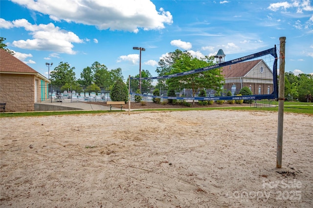 view of property's community with volleyball court and fence