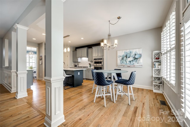 208 Mcduffie Ln, Fort Mill, SC 29715 - dining room with a chandelier, light wood-style flooring, baseboards, ornate columns, and recessed lighting