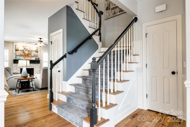 208 Mcduffie Ln, Fort Mill, SC 29715 - stairway featuring wood finished floors, ceiling fan, and a fireplace