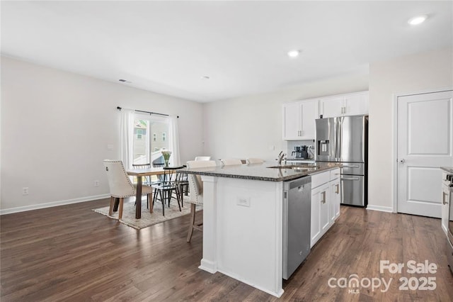 446 Misty Law Ln, Clover, SC 29710 - kitchen with appliances with stainless steel finishes, an island with sink, dark wood-style floors, white cabinetry, and recessed lighting