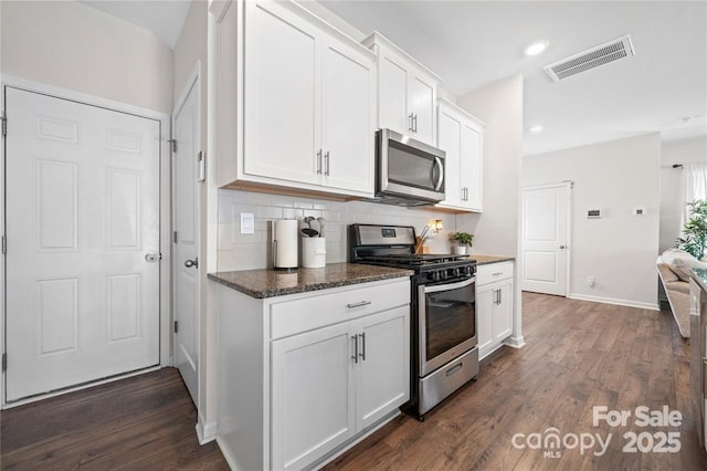 446 Misty Law Ln, Clover, SC 29710 - kitchen with stainless steel appliances, dark wood-style floors, tasteful backsplash, white cabinetry, and recessed lighting