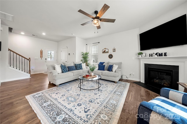 446 Misty Law Ln, Clover, SC 29710 - living area featuring stairway, a ceiling fan, wood finished floors, a glass covered fireplace, and recessed lighting