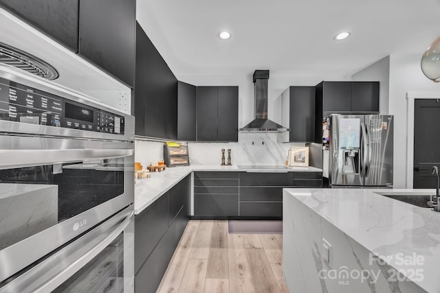 5262 Mckenzie Trl, Conover, NC 28613 - kitchen with stainless steel refrigerator with ice dispenser, wall chimney range hood, dark cabinetry, modern cabinets, and recessed lighting