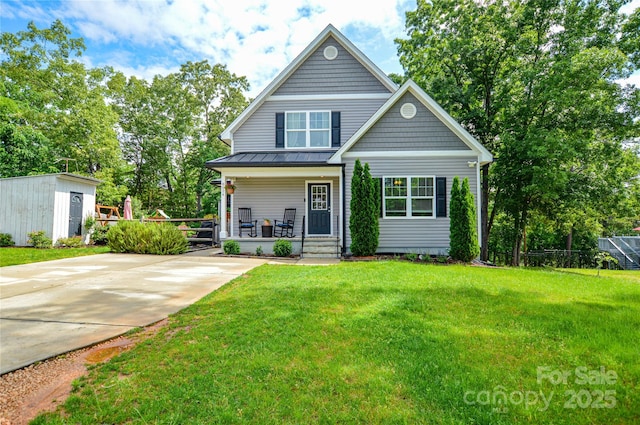 8024 Eagle St, Mount Pleasant, NC 28124 - traditional home with a porch, a front yard, a standing seam roof, and metal roof