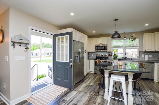 8024 Eagle St, Mount Pleasant, NC 28124 - kitchen featuring appliances with stainless steel finishes, a sink, dark wood-style floors, decorative backsplash, and recessed lighting