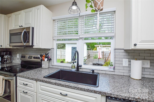 8024 Eagle St, Mount Pleasant, NC 28124 - kitchen featuring stainless steel appliances, a sink, tasteful backsplash, and white cabinets