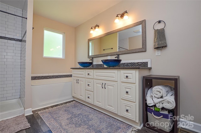 8024 Eagle St, Mount Pleasant, NC 28124 - bathroom with double vanity, wood finished floors, a tile shower, and a bath