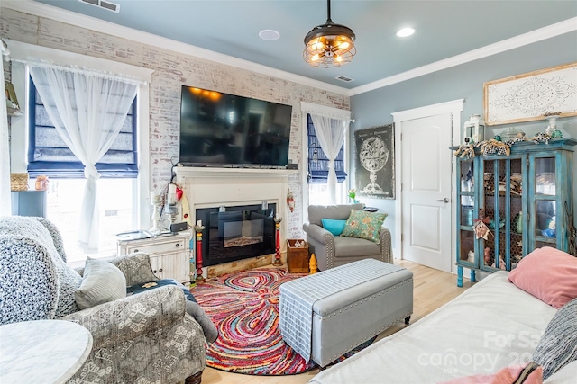 living area with wood finished floors and a glass covered fireplace