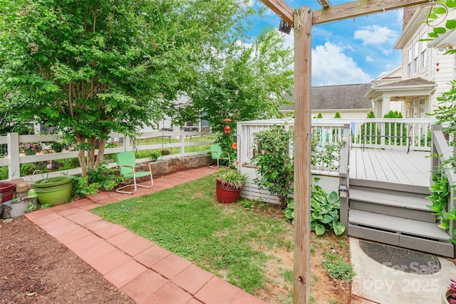 view of yard with fence and a wooden deck