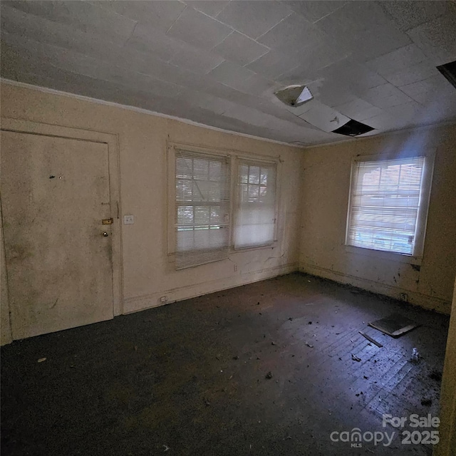 unfurnished room featuring crown molding