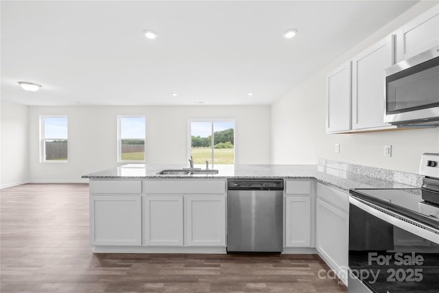 2322 Joes Lake Rd, Shelby, NC 28152 - kitchen with stainless steel appliances, a sink, a peninsula, light stone countertops, and white cabinets