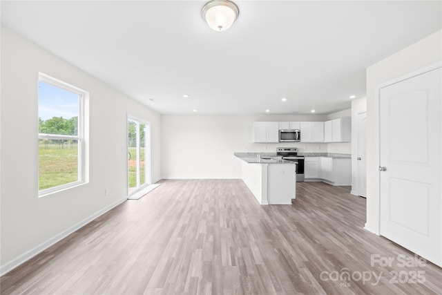 2322 Joes Lake Rd, Shelby, NC 28152 - unfurnished living room featuring recessed lighting, light wood-style flooring, and baseboards