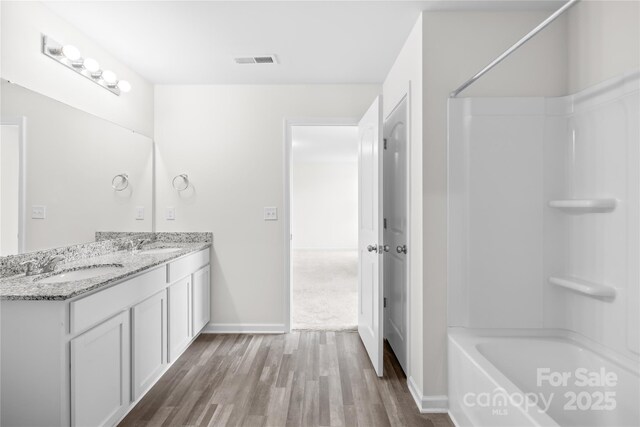 2322 Joes Lake Rd, Shelby, NC 28152 - full bath featuring wood finished floors, double vanity, shower / bath combination, and baseboards