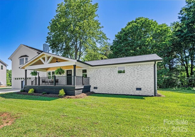 139 Elysian Dr, Mooresville, NC 28117 - view of front facade featuring an attached garage, a front lawn, a chimney, brick siding, and a porch