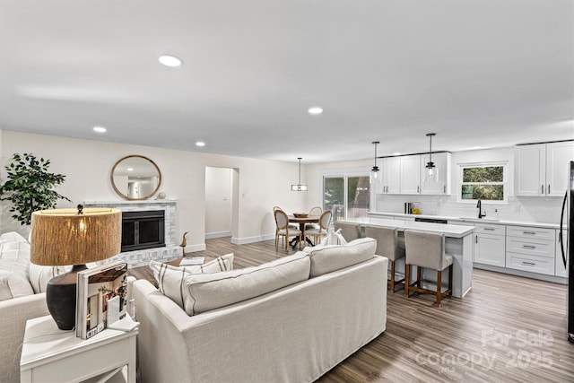 139 Elysian Dr, Mooresville, NC 28117 - living room featuring healthy amount of natural light, recessed lighting, light wood-type flooring, and baseboards
