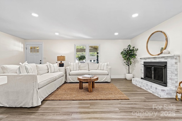 139 Elysian Dr, Mooresville, NC 28117 - living room with a brick fireplace, wood finished floors, recessed lighting, and baseboards