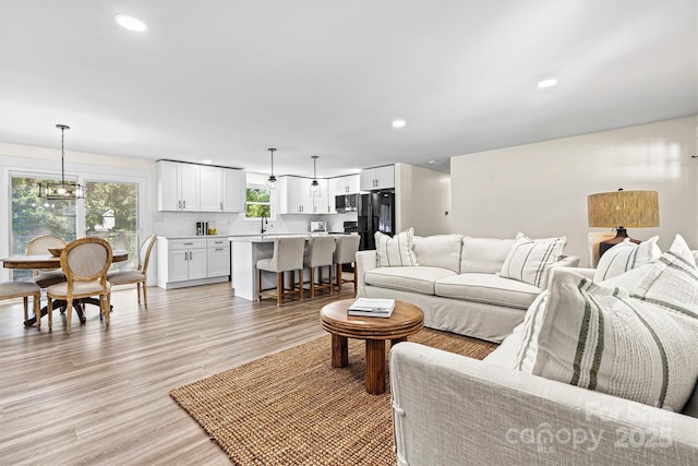 139 Elysian Dr, Mooresville, NC 28117 - living room featuring light wood-type flooring, recessed lighting, and a chandelier