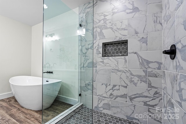 139 Elysian Dr, Mooresville, NC 28117 - bathroom featuring a freestanding tub, walk in shower, wood finished floors, and baseboards