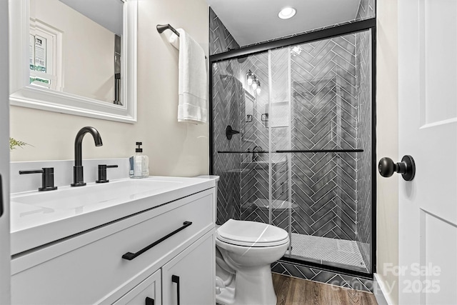 139 Elysian Dr, Mooresville, NC 28117 - bathroom featuring a stall shower, wood finished floors, vanity, toilet, and recessed lighting