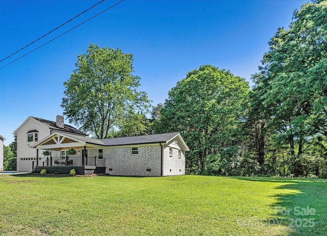139 Elysian Dr, Mooresville, NC 28117 - back of property with crawl space, a lawn, brick siding, and a garage
