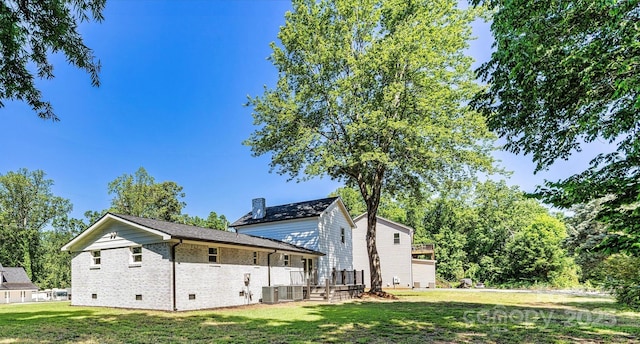 139 Elysian Dr, Mooresville, NC 28117 - view of side of home with a lawn, brick siding, crawl space, a chimney, and cooling unit