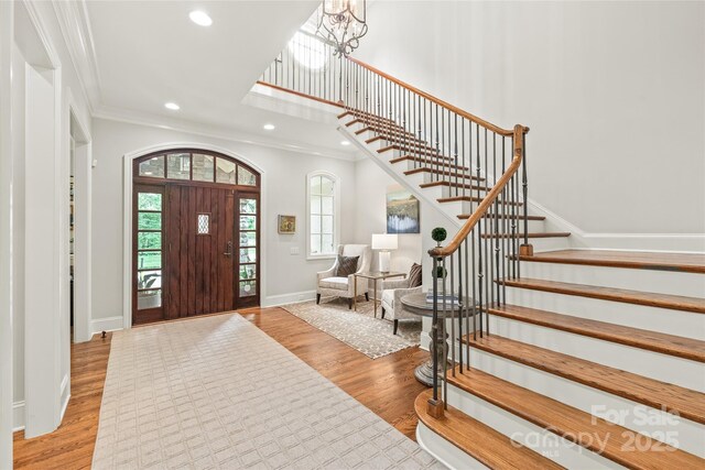 6831 Conservatory Ln, Charlotte, NC 28210 - foyer entrance featuring stairs, light wood-type flooring, recessed lighting, ornamental molding, and baseboards