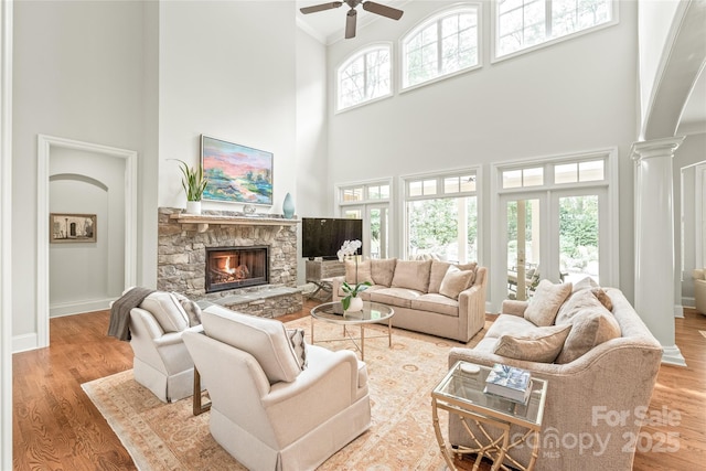 6831 Conservatory Ln, Charlotte, NC 28210 - living area with a high ceiling, ceiling fan, a fireplace, crown molding, and baseboards