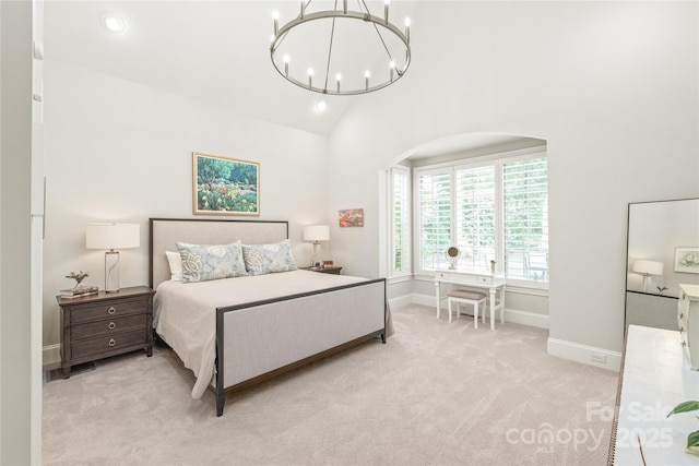 6831 Conservatory Ln, Charlotte, NC 28210 - bedroom featuring a chandelier, light carpet, recessed lighting, baseboards, and arched walkways