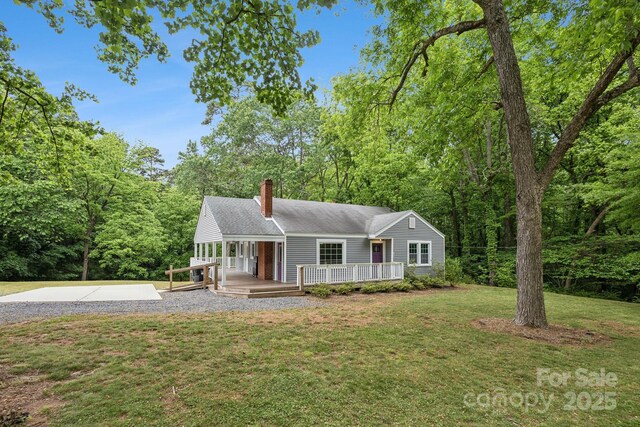 500 Peigler St NW Unit 1 & 2, Concord, NC 28027 - view of front facade featuring a chimney, a front yard, a porch, a shingled roof, and driveway