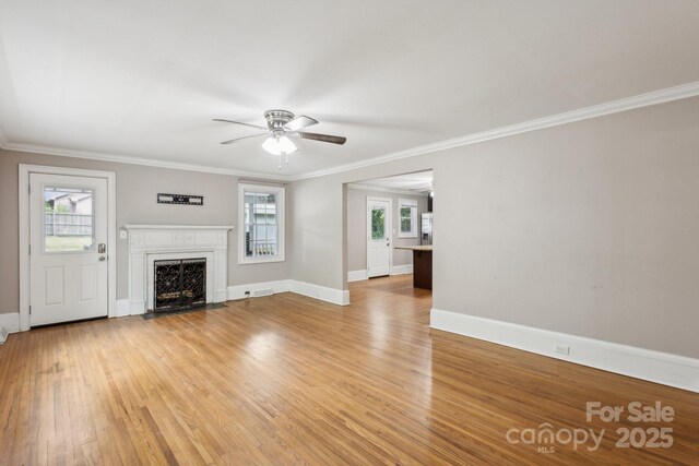 500 Peigler St NW Unit 1 & 2, Concord, NC 28027 - unfurnished living room with plenty of natural light, a ceiling fan, light wood finished floors, a high end fireplace, and crown molding