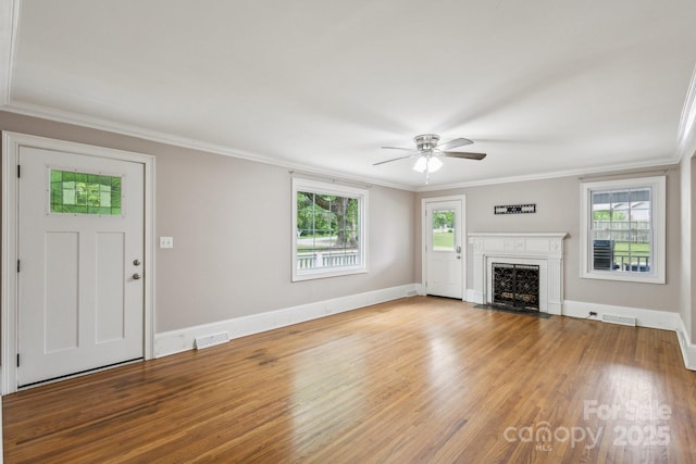 500 Peigler St NW Unit 1 & 2, Concord, NC 28027 - unfurnished living room featuring a ceiling fan, plenty of natural light, crown molding, a fireplace with flush hearth, and baseboards