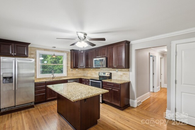 500 Peigler St NW Unit 1 & 2, Concord, NC 28027 - kitchen featuring stainless steel appliances, a sink, ceiling fan, dark brown cabinets, and crown molding