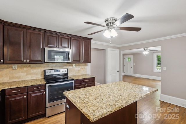 500 Peigler St NW Unit 1 & 2, Concord, NC 28027 - kitchen featuring stainless steel appliances, ceiling fan, baseboards, backsplash, and crown molding