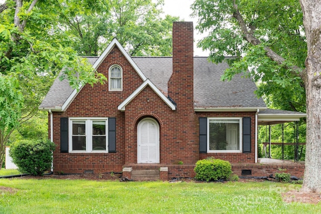 4098 S NC Highway 127, Hickory, NC 28602 - tudor-style house featuring brick siding, a chimney, roof with shingles, and a front yard