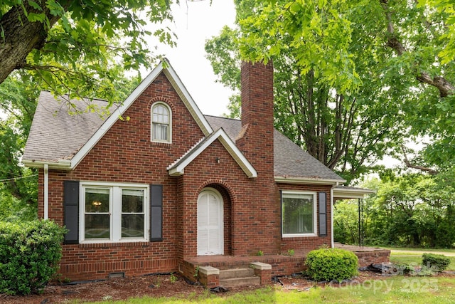 4098 S NC Highway 127, Hickory, NC 28602 - view of front facade with a chimney, brick siding, and roof with shingles