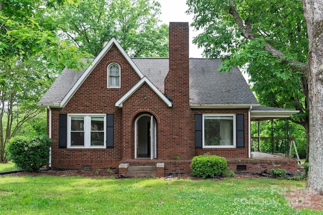 4098 S NC Highway 127, Hickory, NC 28602 - english style home featuring brick siding, a front yard, a chimney, and roof with shingles
