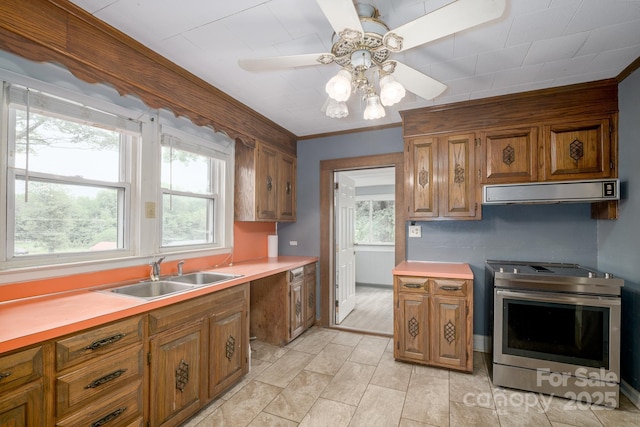 4098 S NC Highway 127, Hickory, NC 28602 - kitchen with electric range, exhaust hood, a sink, brown cabinetry, and light countertops