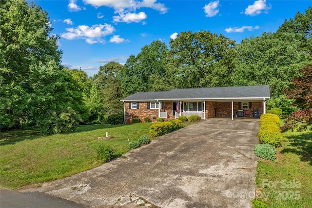 157 E Meadowview Dr, Statesville, NC 28625 - single story home featuring a porch, concrete driveway, a front yard, an attached carport, and brick siding