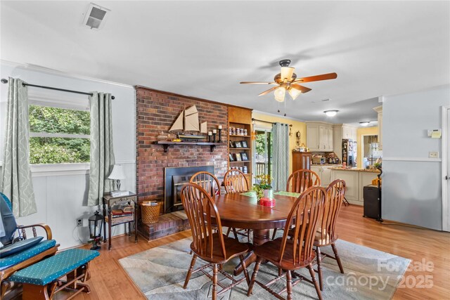157 E Meadowview Dr, Statesville, NC 28625 - dining space with ceiling fan, light wood-style flooring, and a fireplace