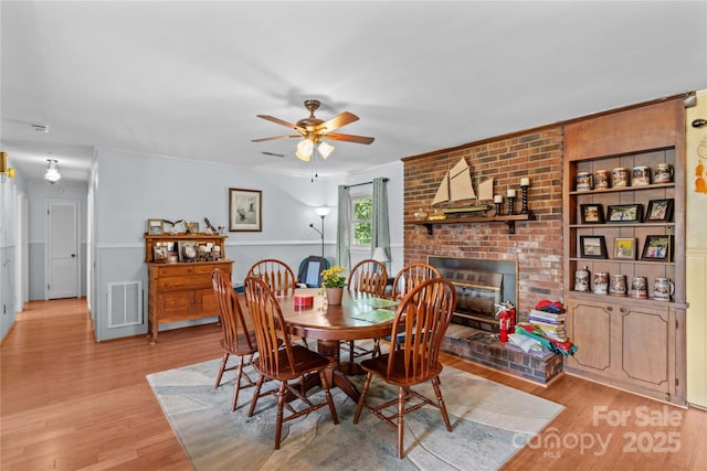 157 E Meadowview Dr, Statesville, NC 28625 - dining space with ceiling fan, light wood-style floors, and a fireplace