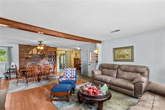 157 E Meadowview Dr, Statesville, NC 28625 - living area with a textured ceiling, wood finished floors, beam ceiling, and ceiling fan