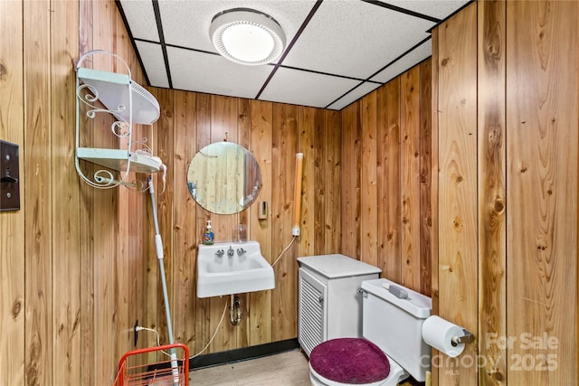 157 E Meadowview Dr, Statesville, NC 28625 - bathroom featuring a paneled ceiling, a sink, wood walls, wood finished floors, and toilet